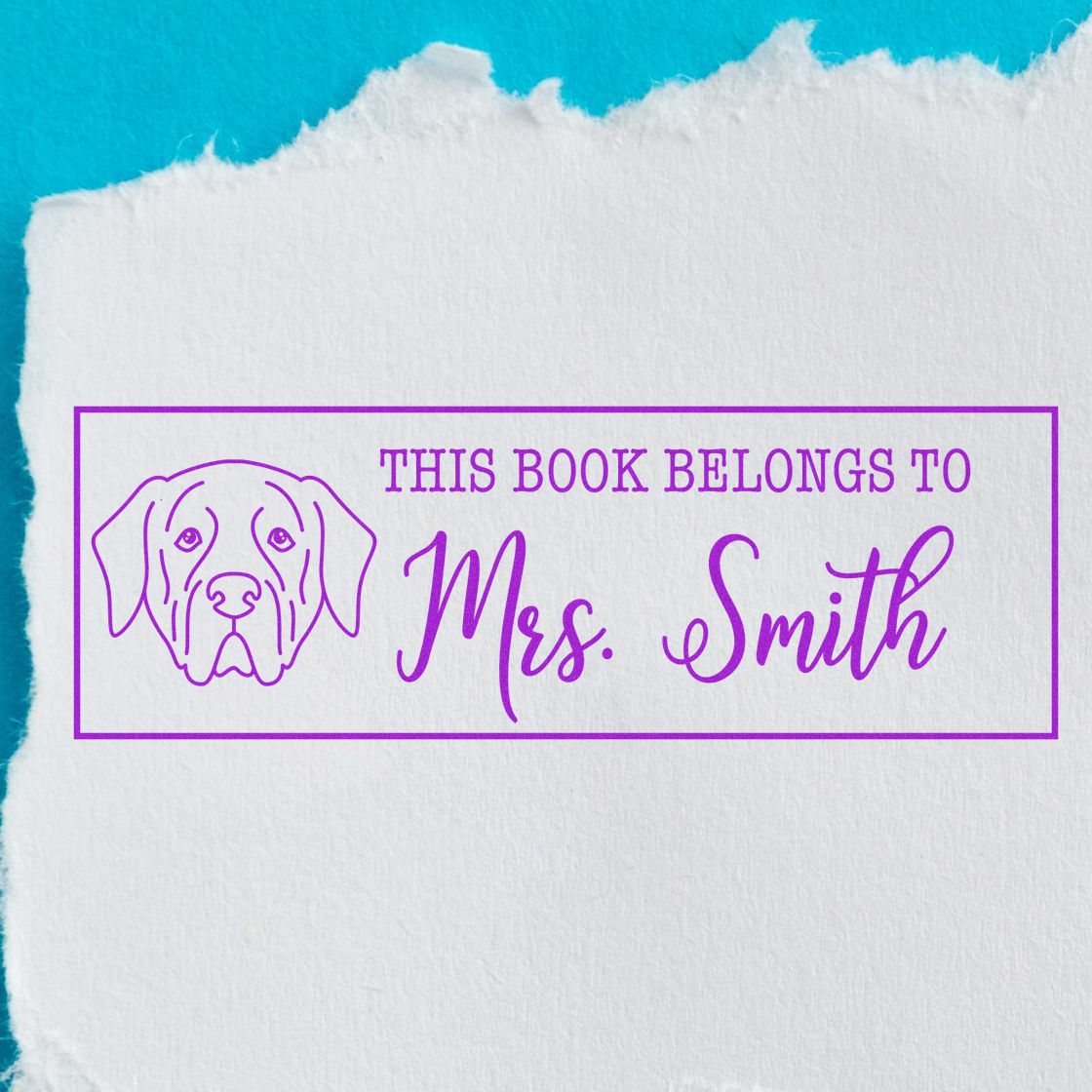 Purple personalized book stamp with dog outline and This Book Belongs to Mrs. Smith on white paper, turquoise background.