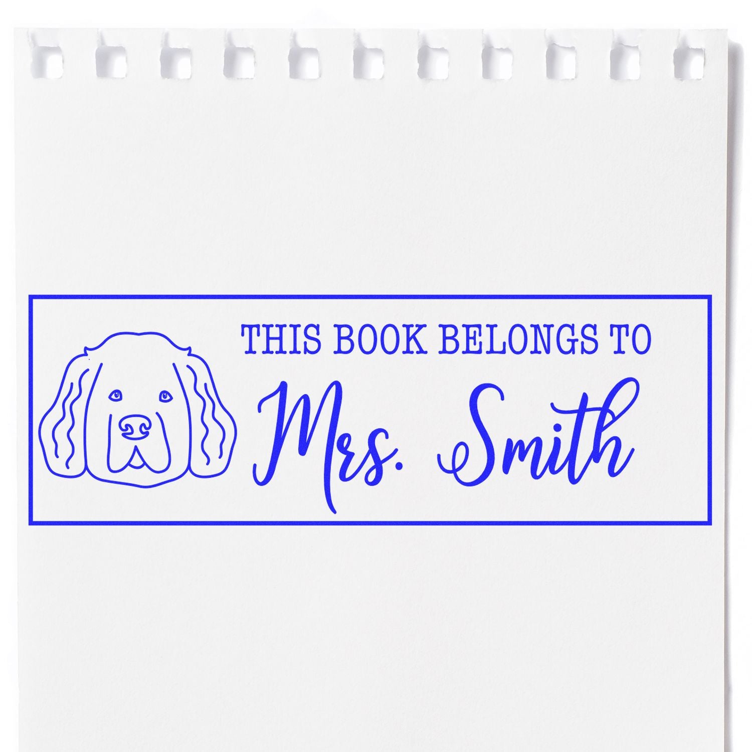 Blue custom book stamp and seal with dog outline and This Book Belongs to Mrs. Smith on white paper.