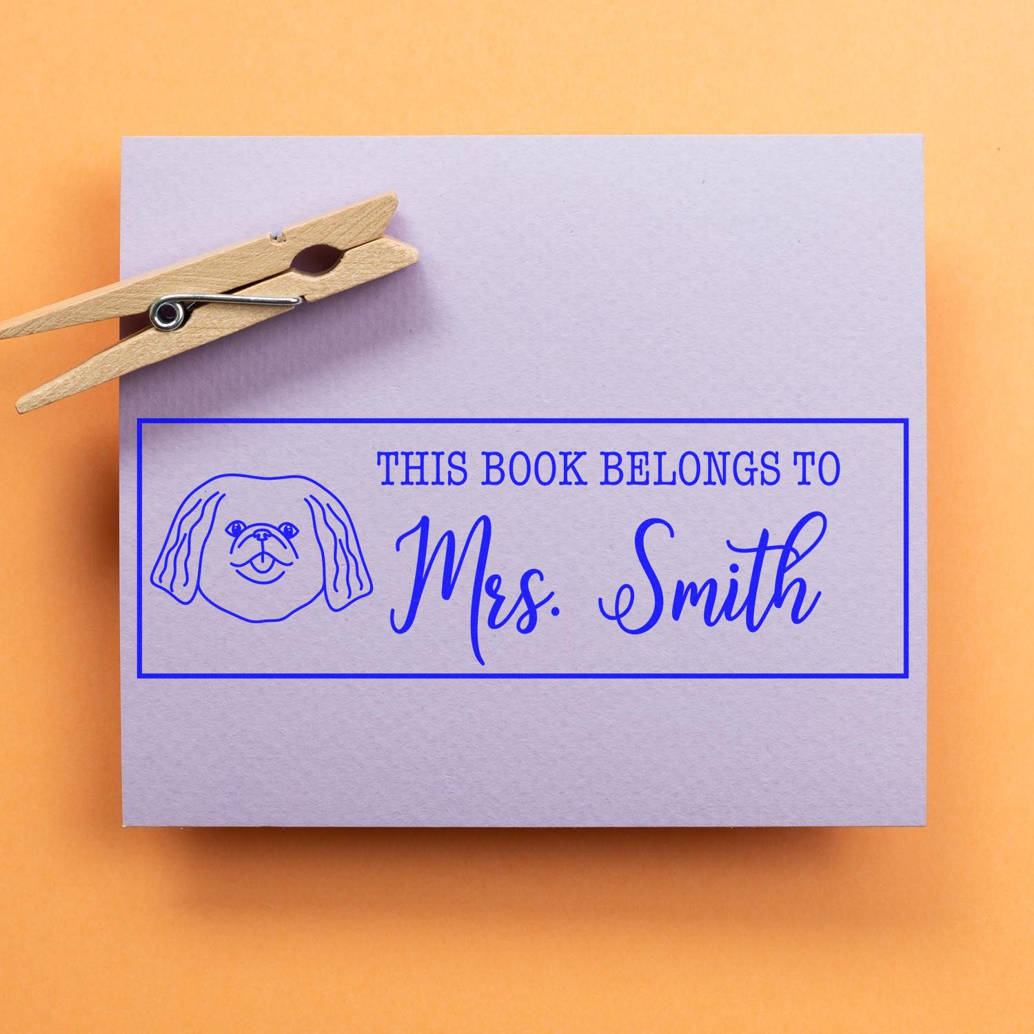Custom Pekingese dog rubber stamp with wood handle from ESS, showing the stamp in use for personalized bookplates.