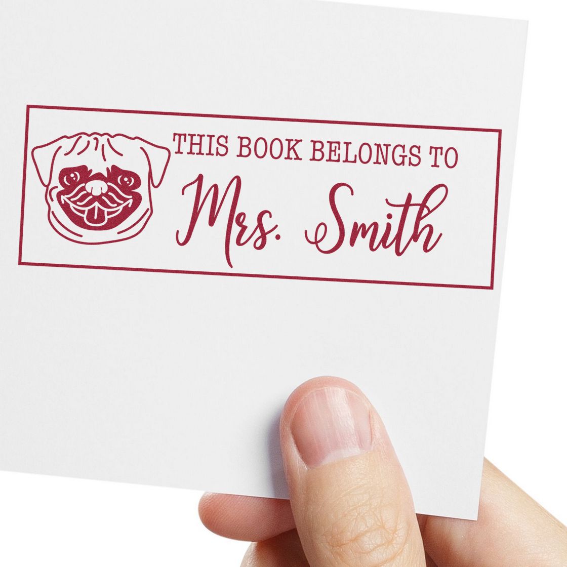 Maroon personalized book stamp and seal with pug icon and This Book Belongs to Mrs. Smith on white paper.