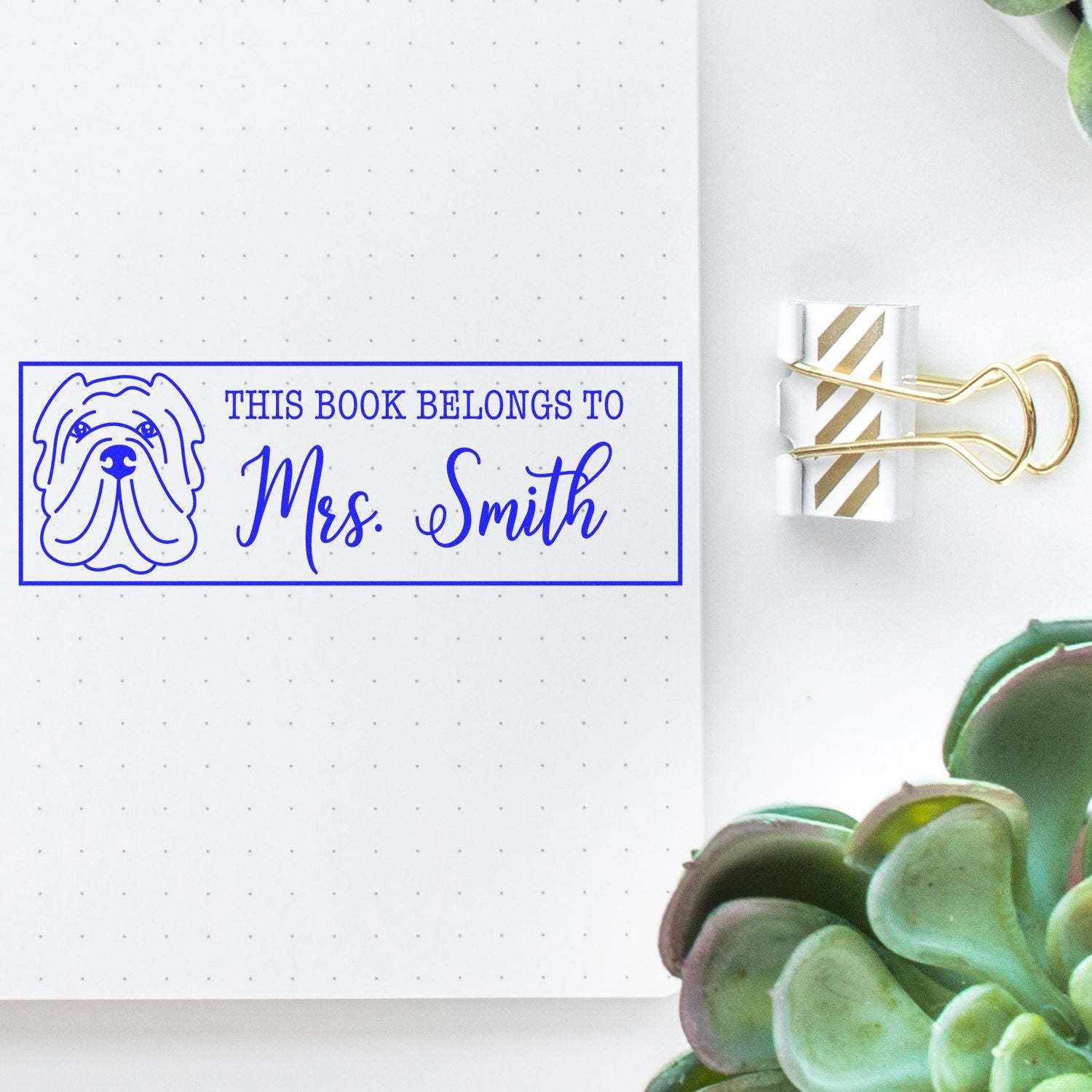 Blue custom book stamp with dog icon and Mrs. Smith, clipped beside a white-and-gold striped wax seal.