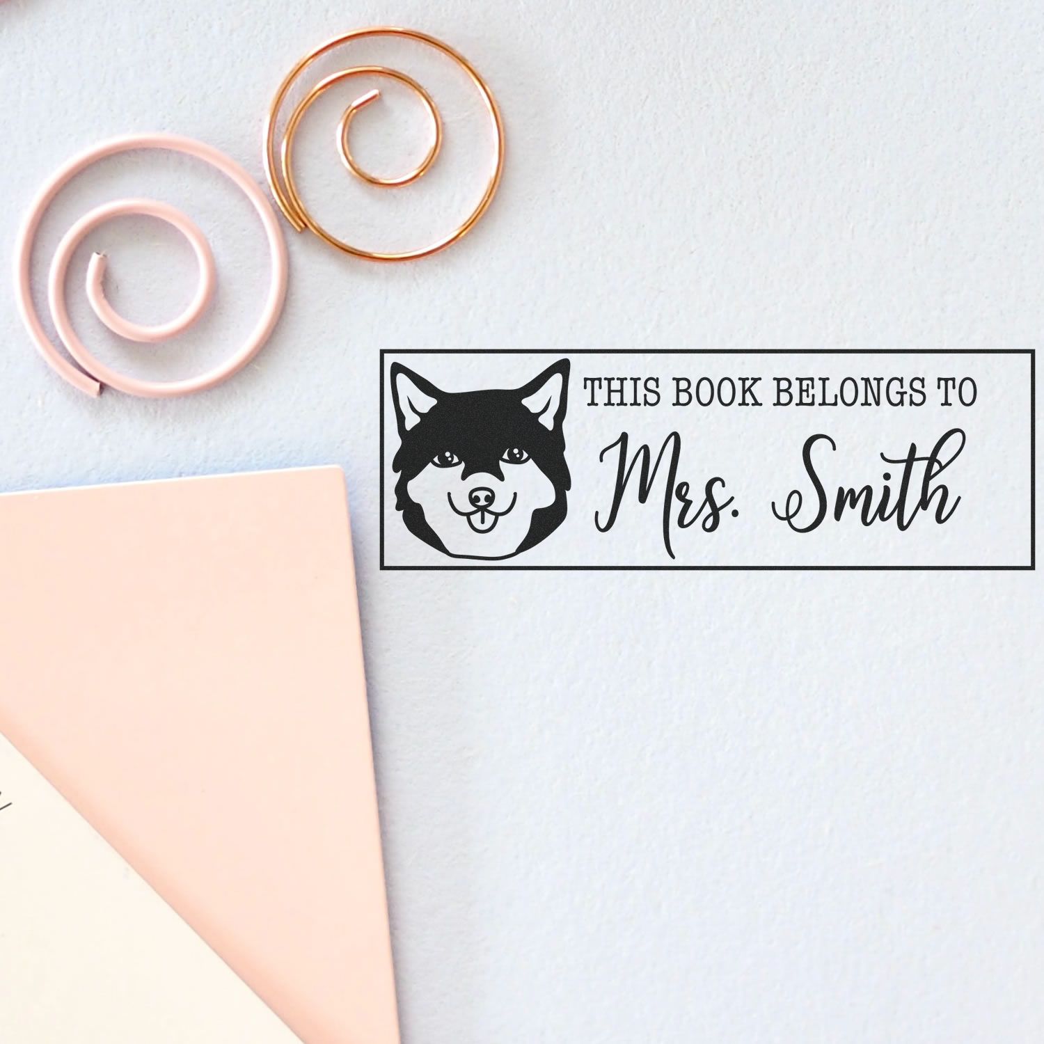 Custom black book stamp with husky icon and This Book Belongs to Mrs. Smith, beside blush and rose gold spiral seals.
