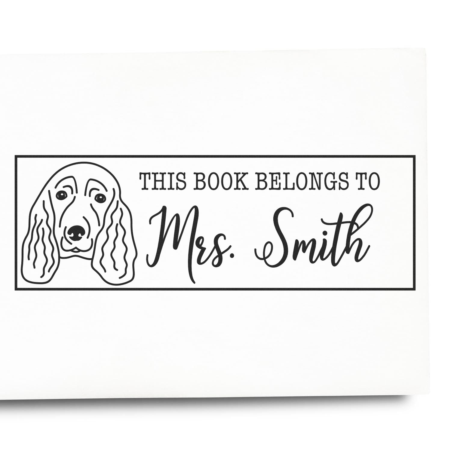 Black-and-white custom book stamp with dog illustration and text This Book Belongs to Mrs. Smith