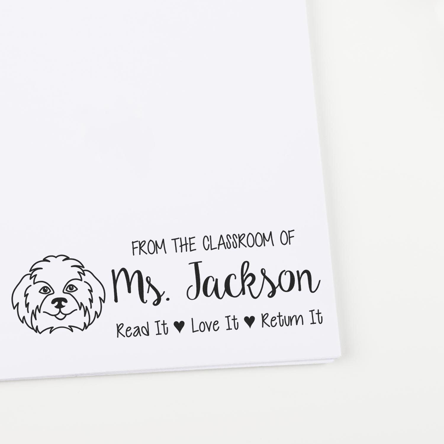Black custom classroom stamp seal with dog illustration and Ms. Jackson Read It, Love It, Return It on white background.