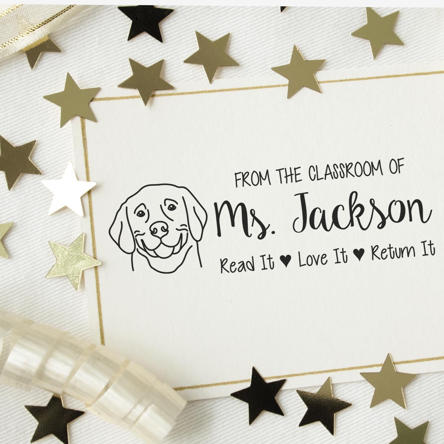 Personalized classroom stamp and seal with black dog line art and Ms. Jackson text, on white card with gold border and star confetti.