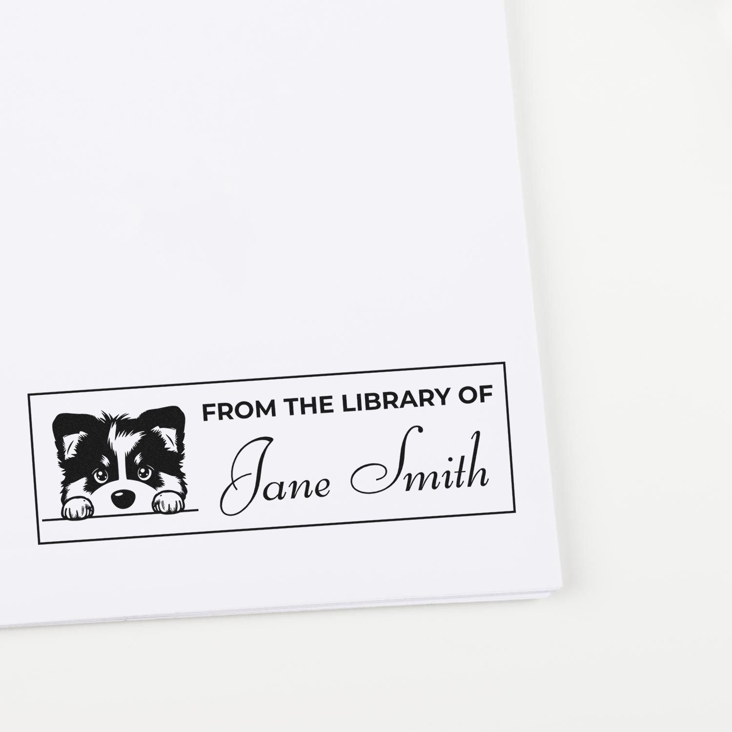 Black custom library stamp with puppy illustration and From the Library of Jane Smith on white paper.