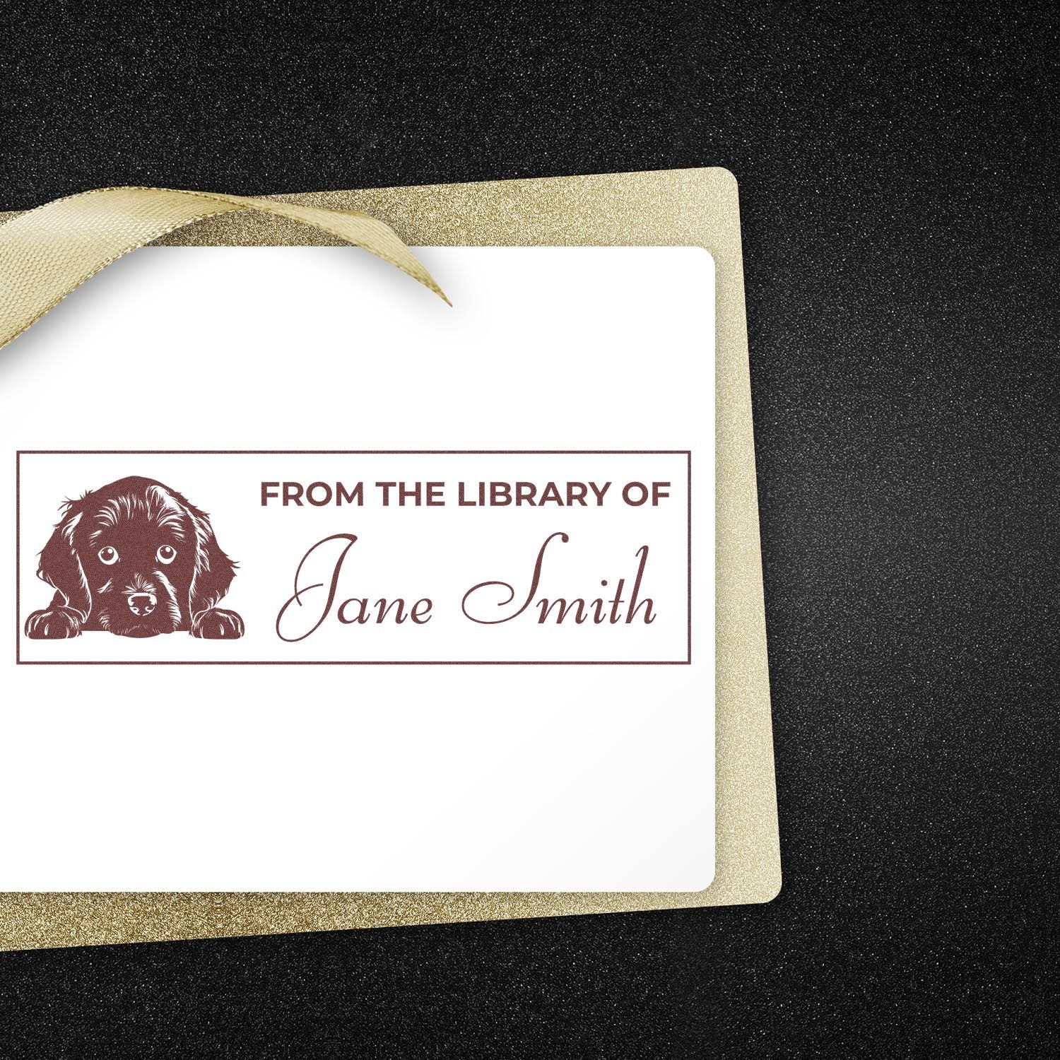 Personalized brown bookplate stamp/seal with dog icon and Jane Smith on white card, gold glitter border on black background