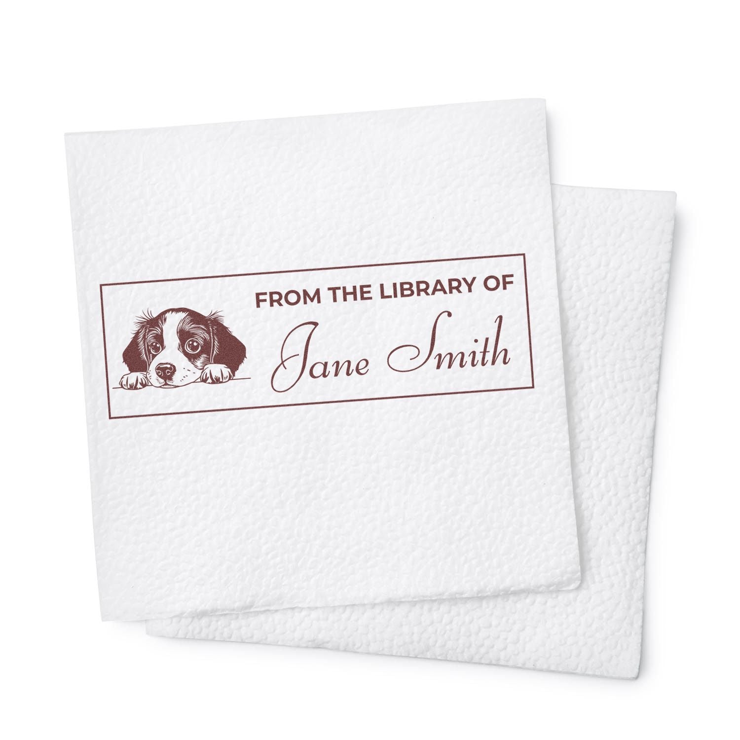 White embossed paper with brown custom library stamp and seal reading From the Library of Jane Smith with a dog illustration.