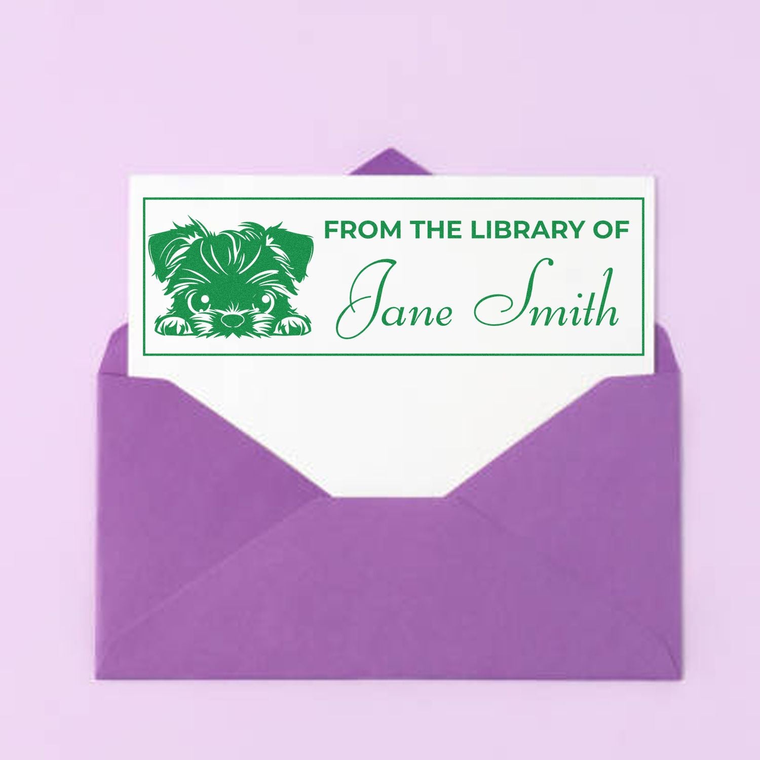 Green custom library stamp seal with puppy graphic and Jane Smith on a white card in a purple envelope.