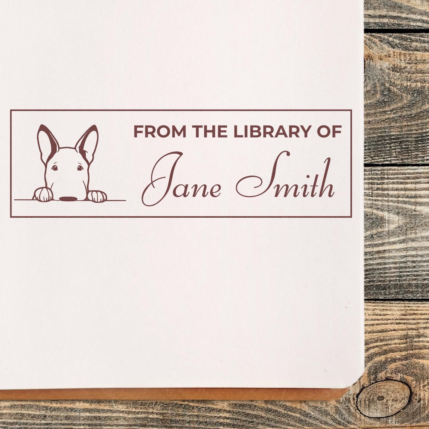 Brown custom library stamp and seal with dog illustration and From the Library of Jane Smith on white paper.