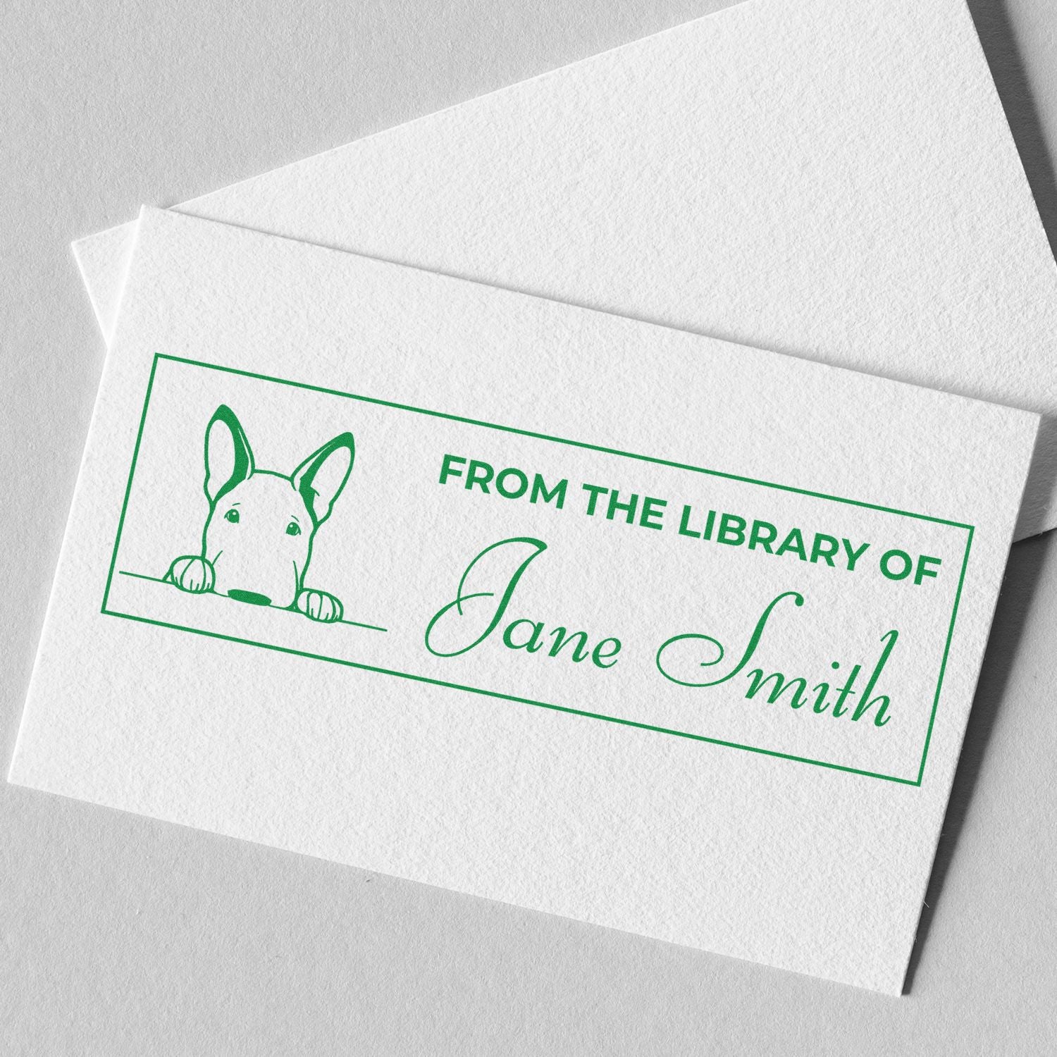Green custom library stamp and seal on white paper with dog illustration and From the Library of Jane Smith text.
