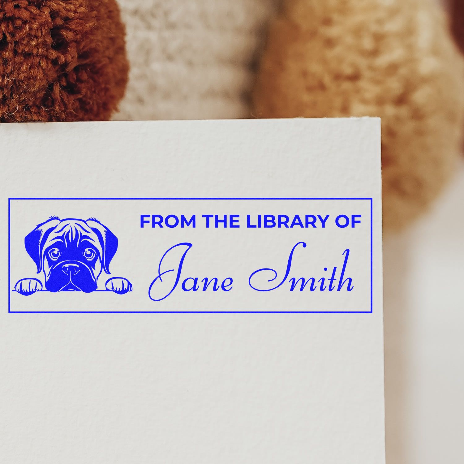 Blue custom library stamp and seal with dog graphic, From the Library of Jane Smith on white paper.