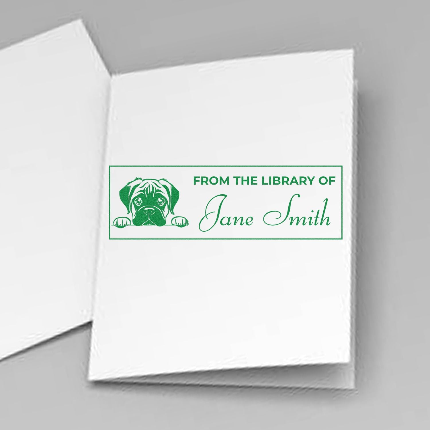 Green custom library stamp/seal with dog graphic and Jane Smith text on white paper.