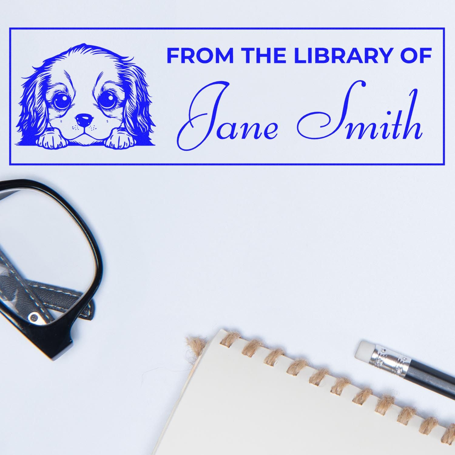 Blue personalized stamp and seal with puppy illustration and From the Library of Jane Smith text on white background.