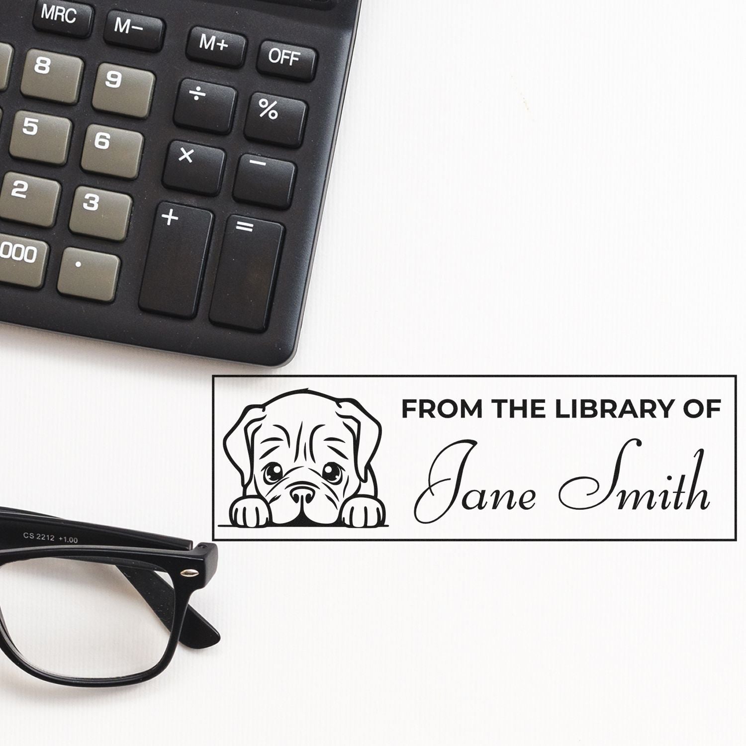 Custom black library stamp and seal with dog illustration and Jane Smith name, beside calculator and eyeglasses.