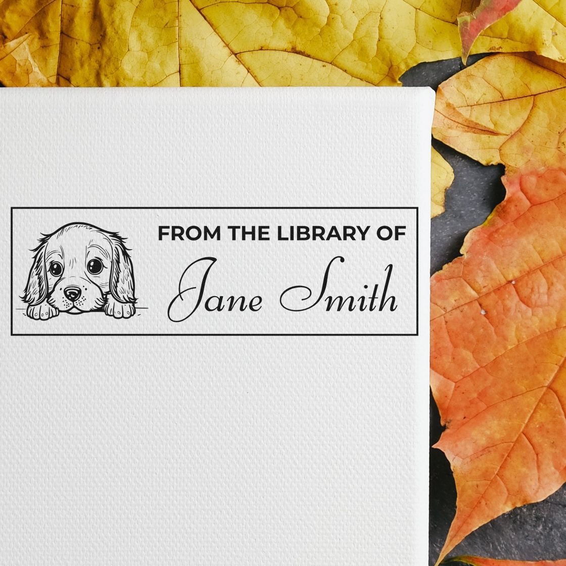 Custom library stamp seal with puppy illustration and Jane Smith name on white paper, framed by yellow and orange autumn leaves.