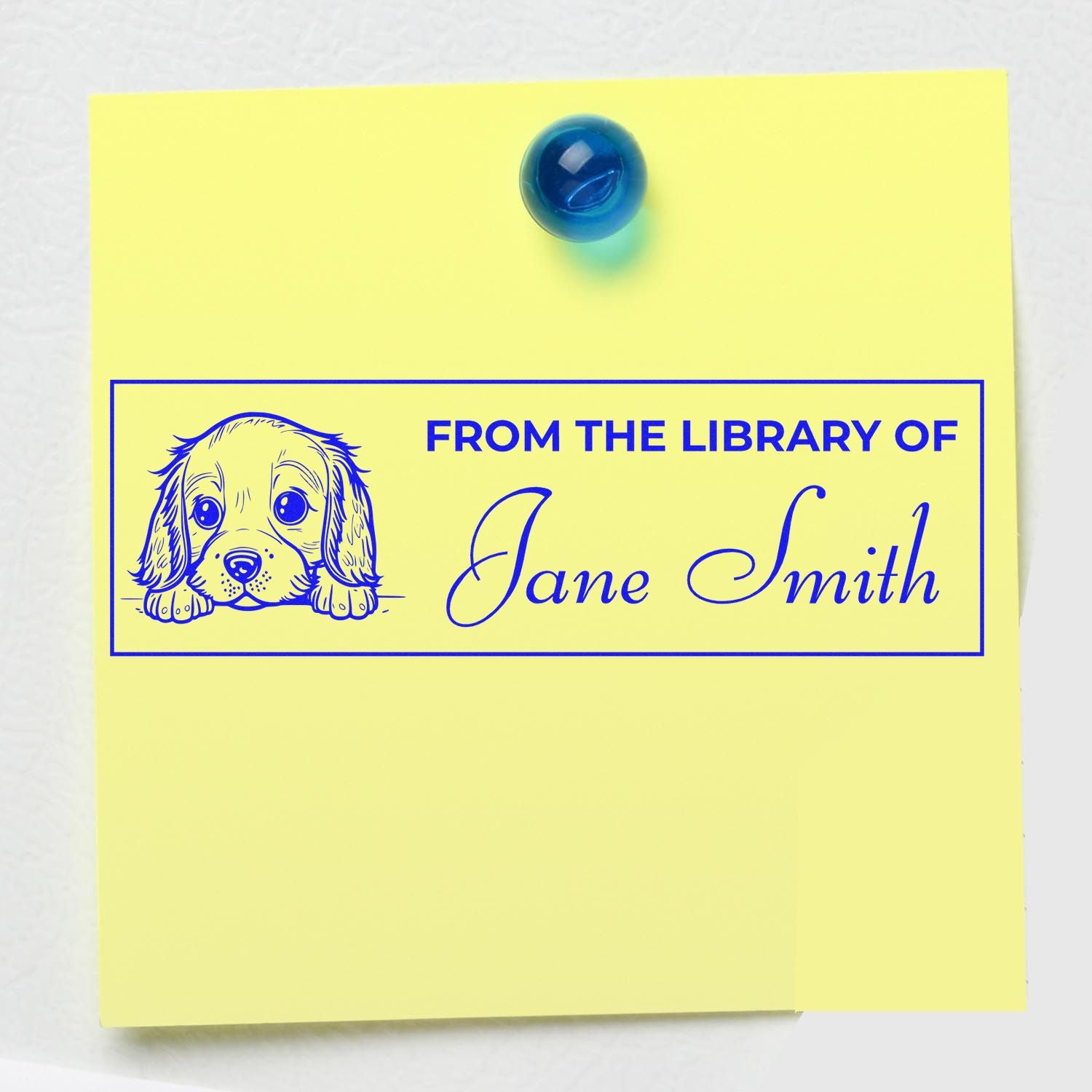 Yellow sticky note with blue custom library stamp seal, puppy illustration, and From the Library of Jane Smith text.