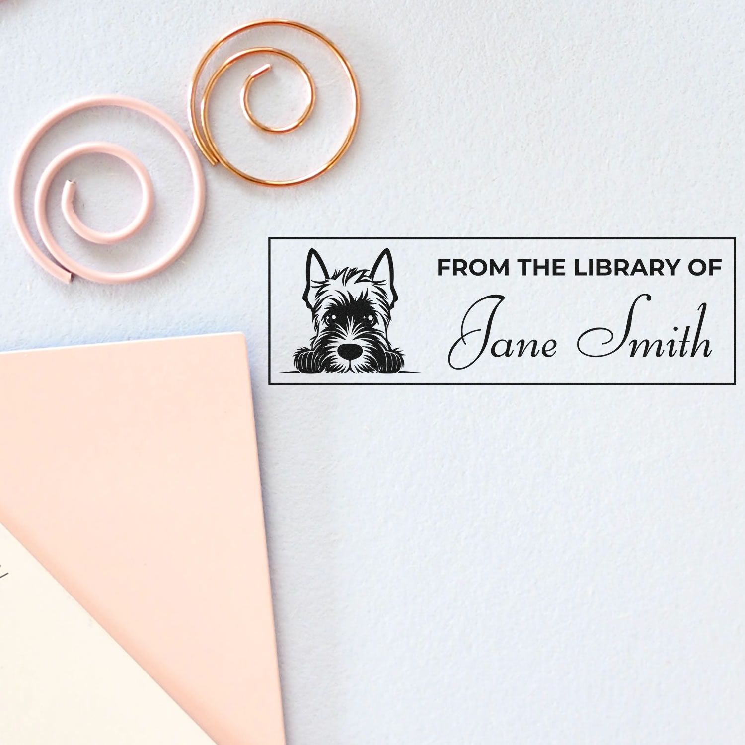 Custom library stamp with dog illustration and Jane Smith, plus pink and gold spiral sealing wax seals on white paper.