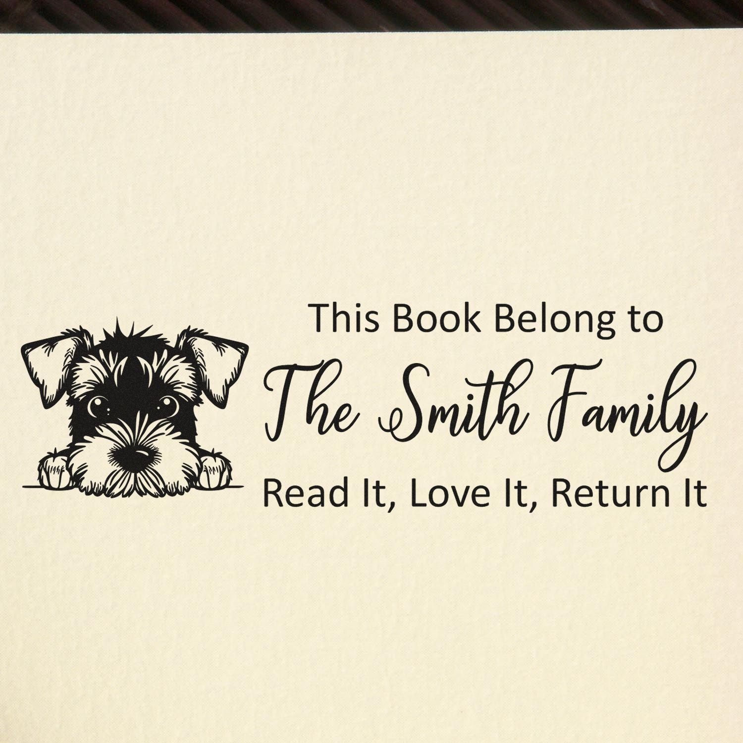 Cream bookplate stamp with black schnauzer and text: This Book Belong to The Smith Family, Read It, Love It, Return It