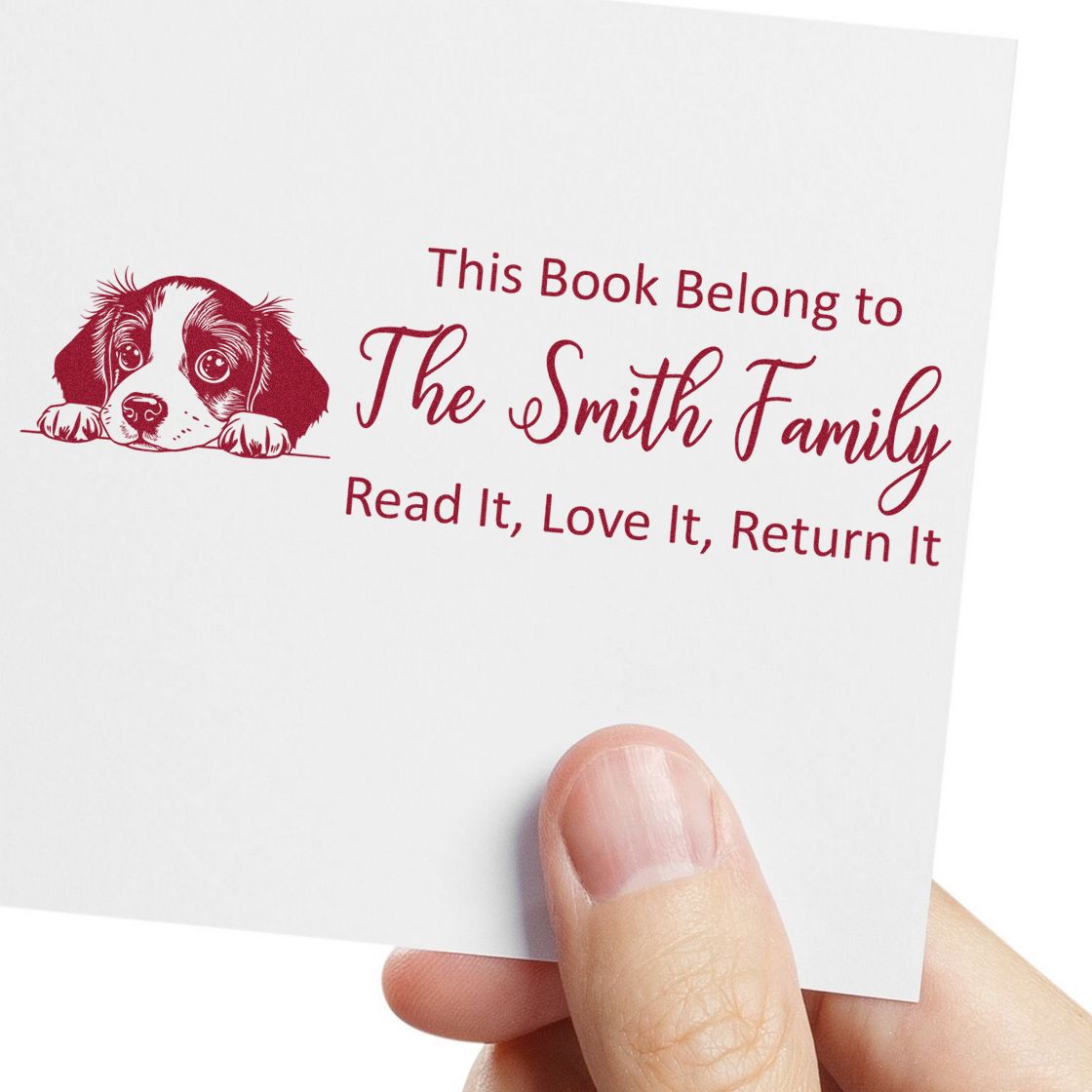 Burgundy custom book stamp seal with puppy illustration and The Smith Family bookplate return message on white card.