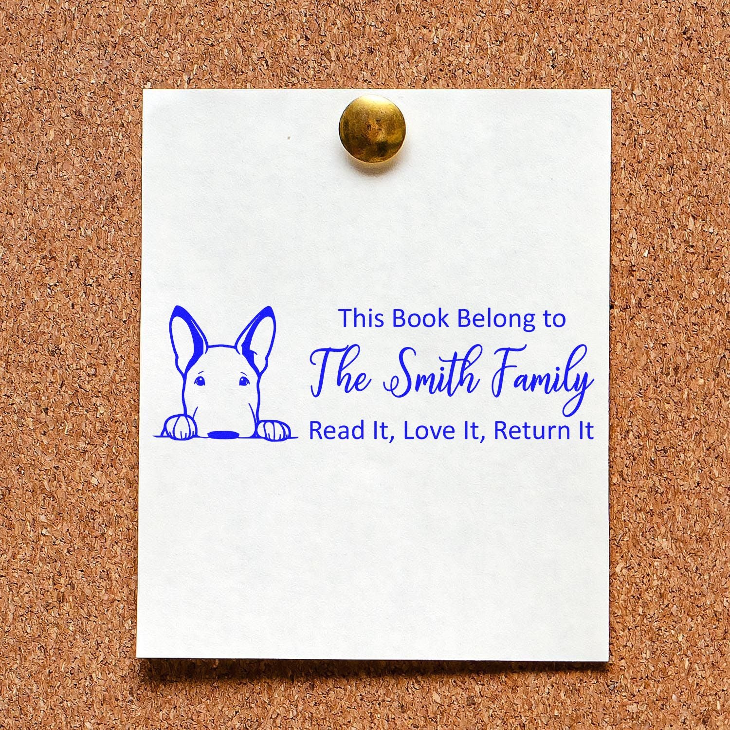 Blue custom bookplate stamp with dog icon and The Smith Family text on white paper pinned to corkboard.