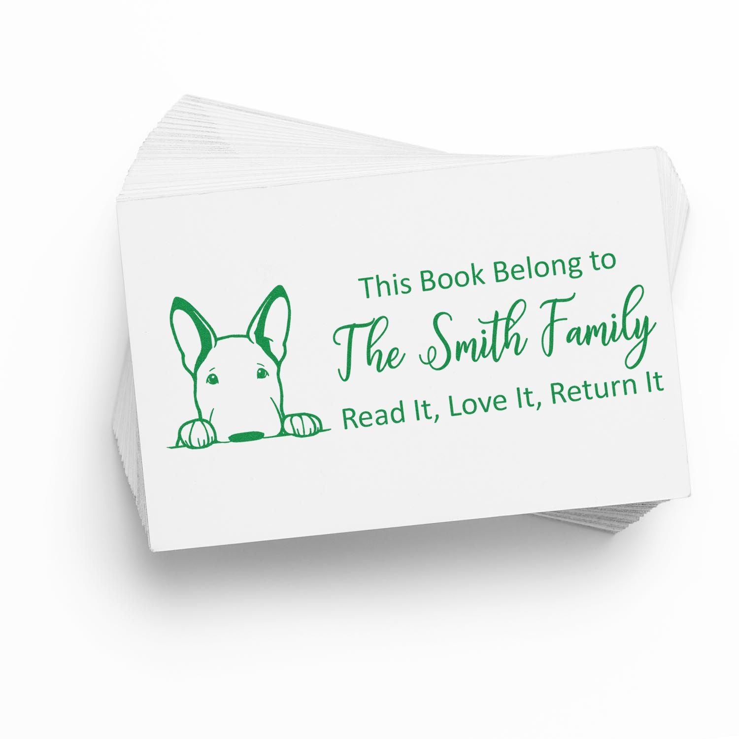 Green self-inking book stamp with dog graphic and This Book Belong to The Smith Family on white cards.
