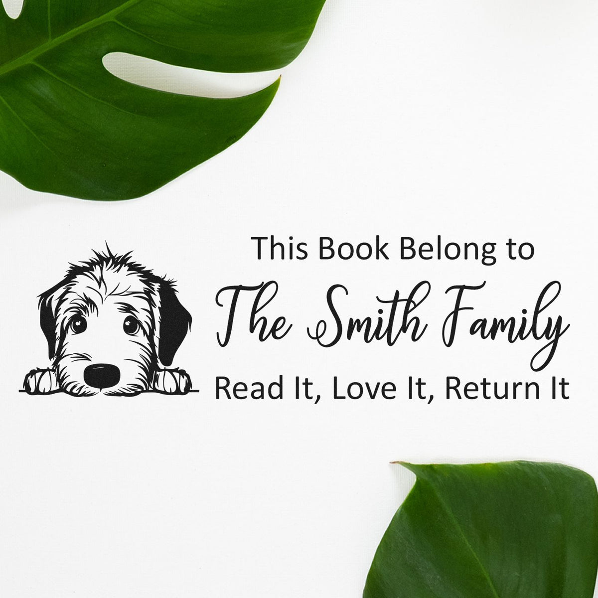Black custom book stamp and seal with dog illustration, The Smith Family and Read It, Love It, Return It on white with green leaves.