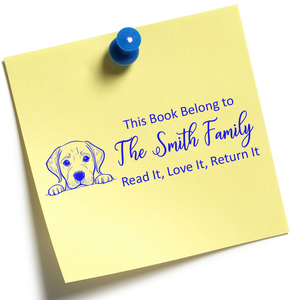 Yellow note with blue custom bookplate stamp, dog illustration, and push pin reading The Smith Family.