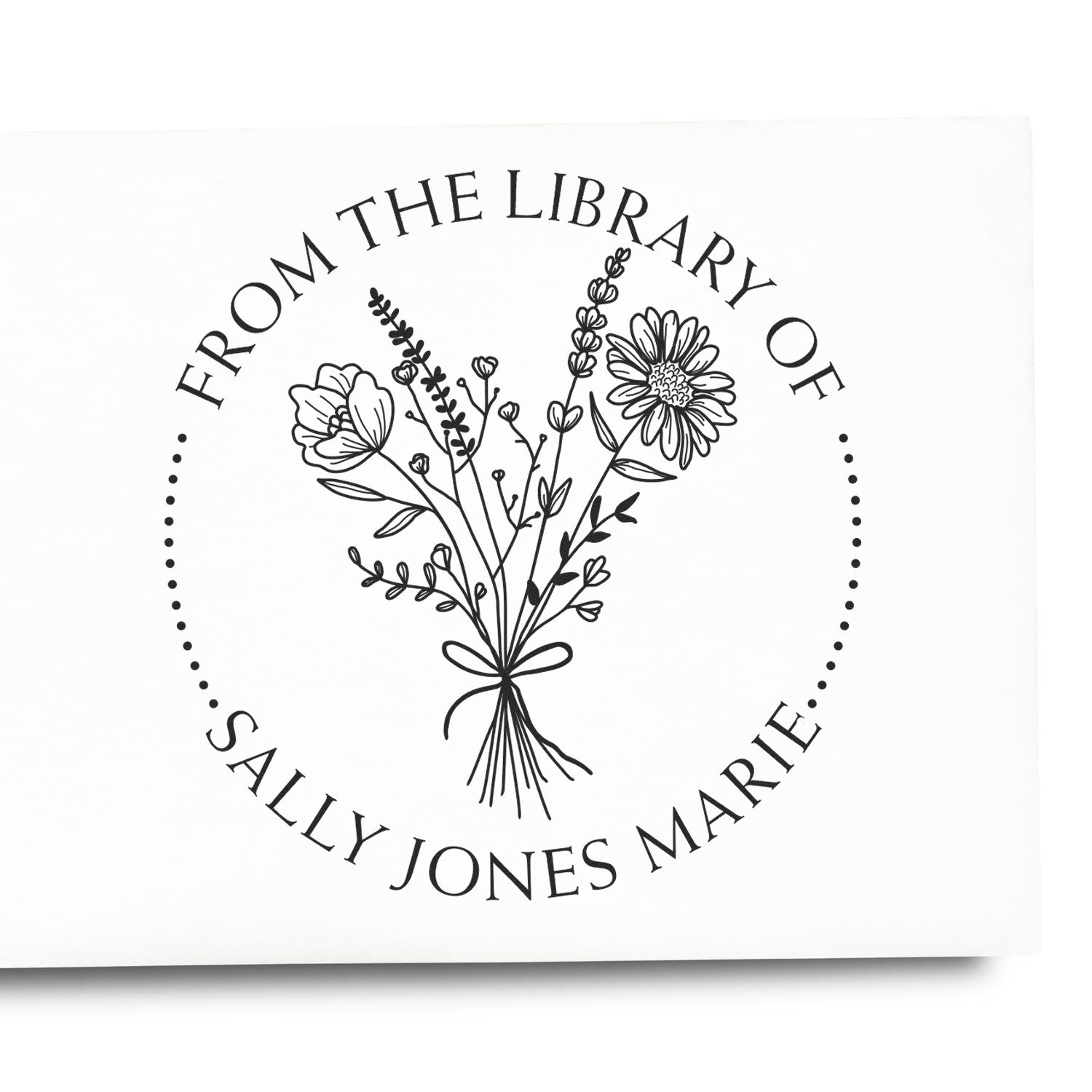 Black custom library stamp seal with floral bouquet, dotted border, and circular text for Sally Jones Marie on white.