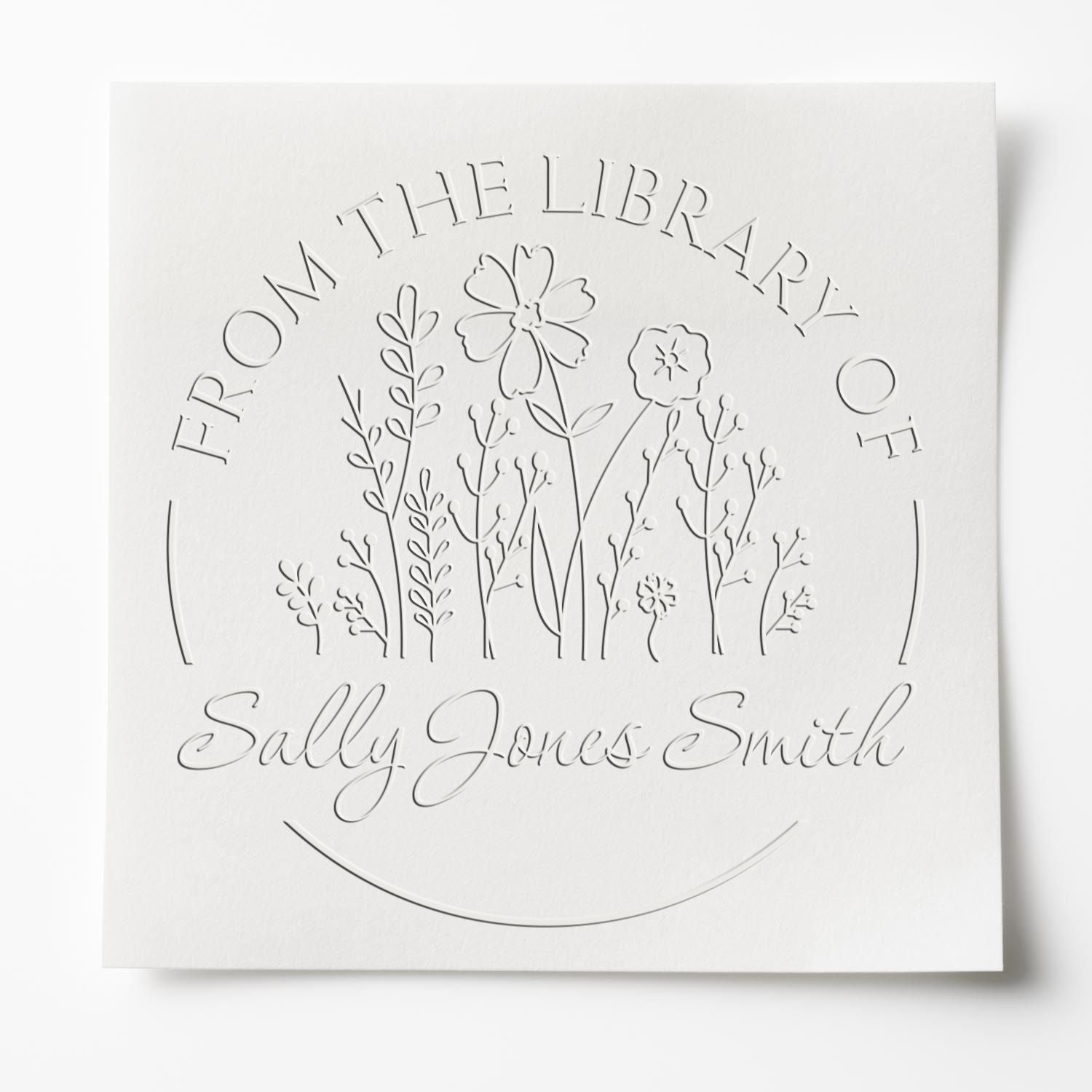 White embossed library stamp and seal with floral line art and text From the Library of Sally Jones Smith
