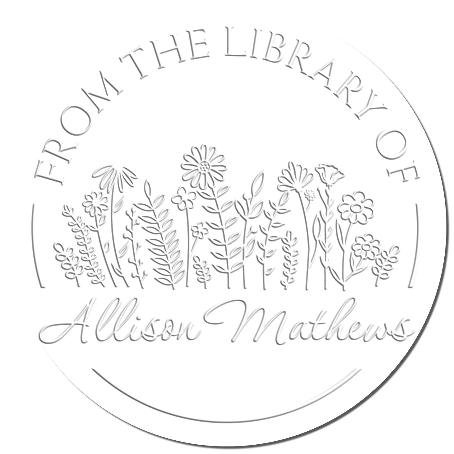 Round silver library embosser seal with wildflower line art and From the Library of Allison Mathews on white.