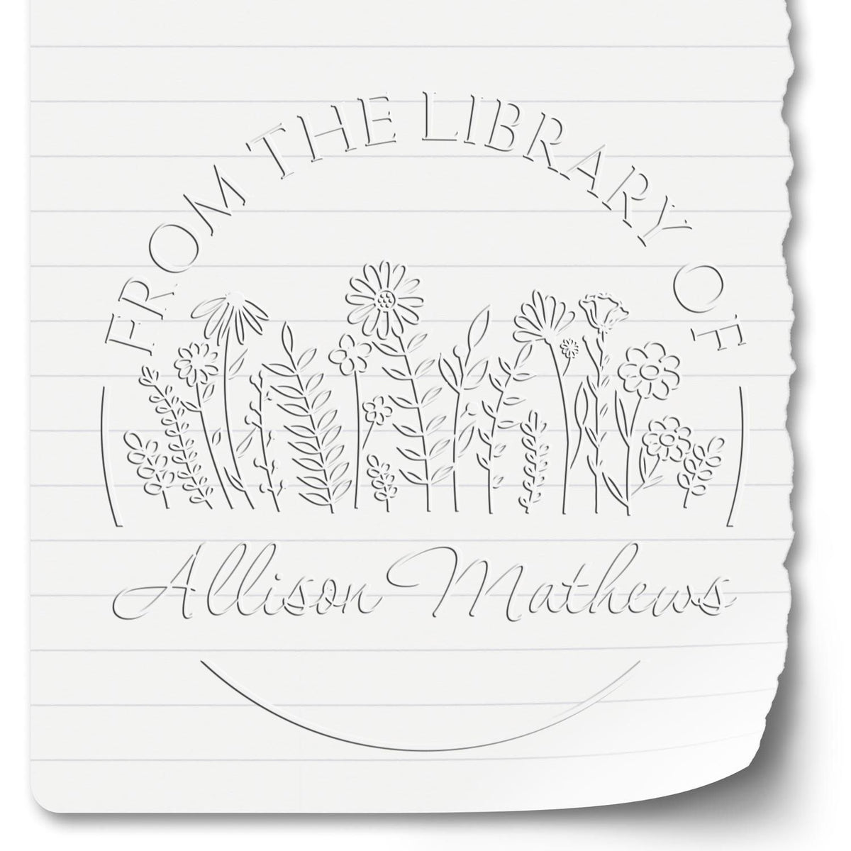 Shiny floral stamp with custom book lover embossing seal in use, featuring intricate flower design on a stamping surface.