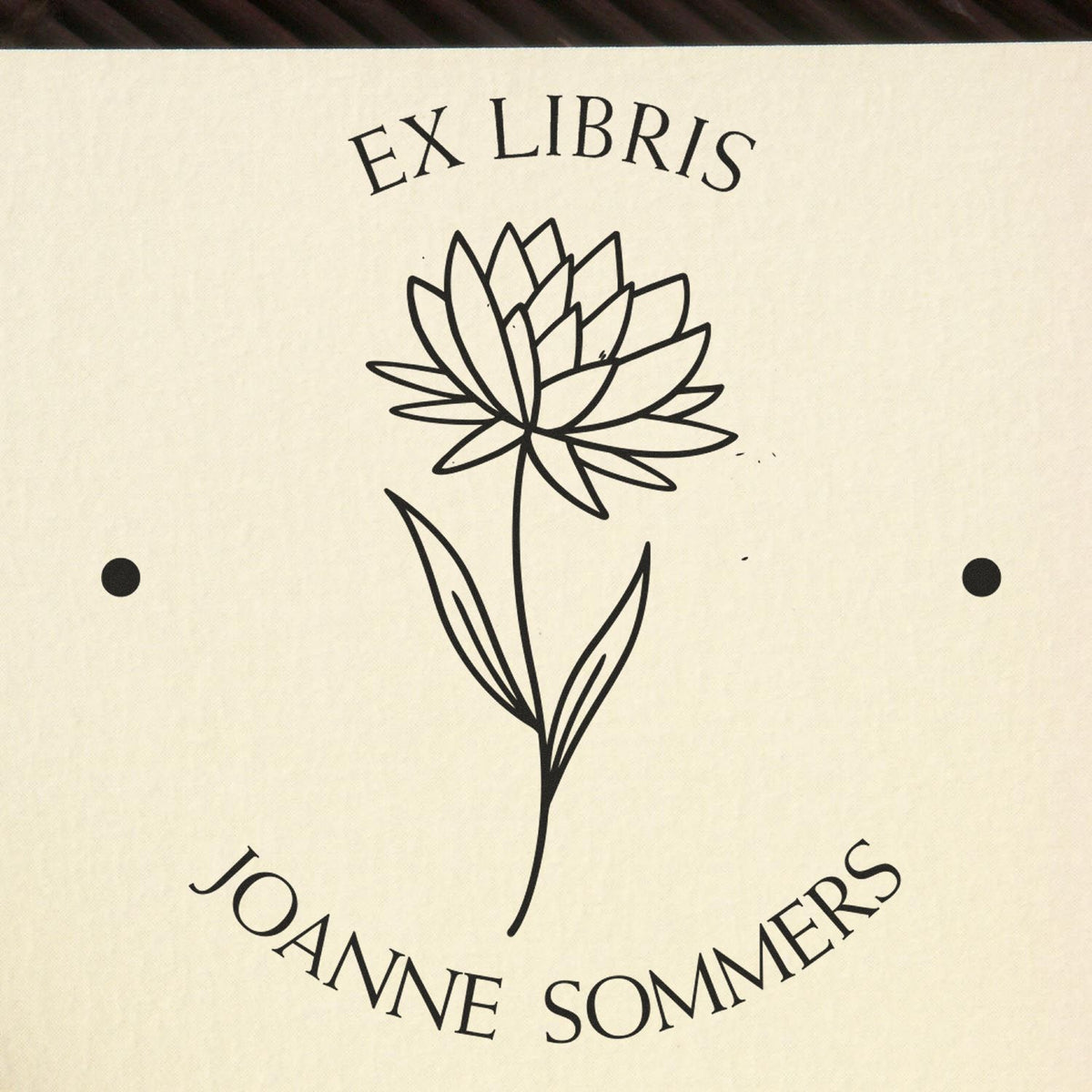 Cream ex libris stamp seal with black floral line art and text EX LIBRIS and JOANNE SOMMERS.