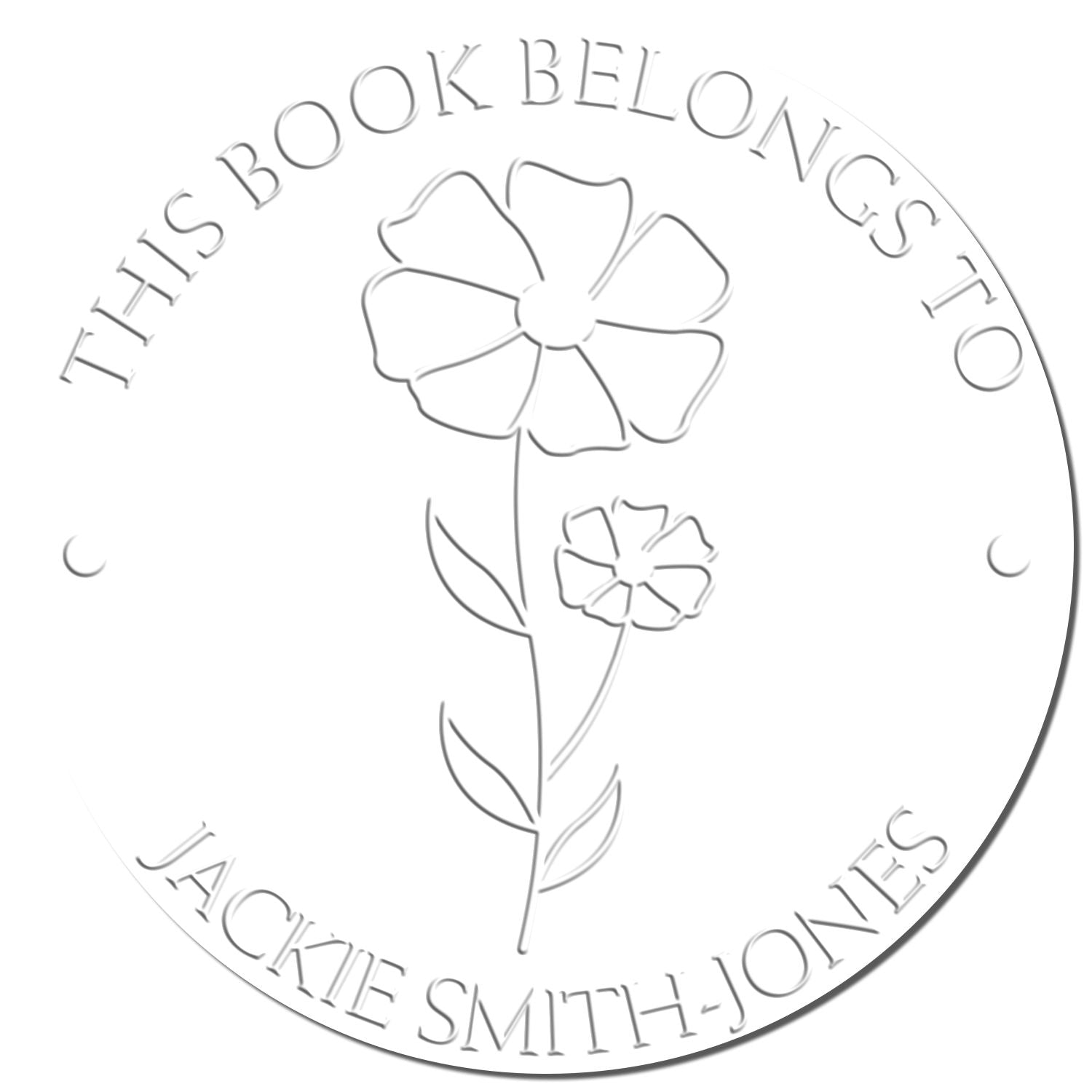 Embossed silver bookplate seal with flower, reading This Book Belongs to Jackie Smith-Jones.