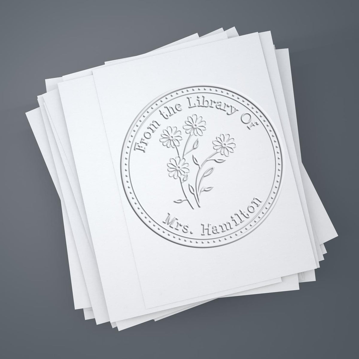 Shiny floral stamp featuring a colorful daisy bouquet design, used as a custom personal library paper embosser.