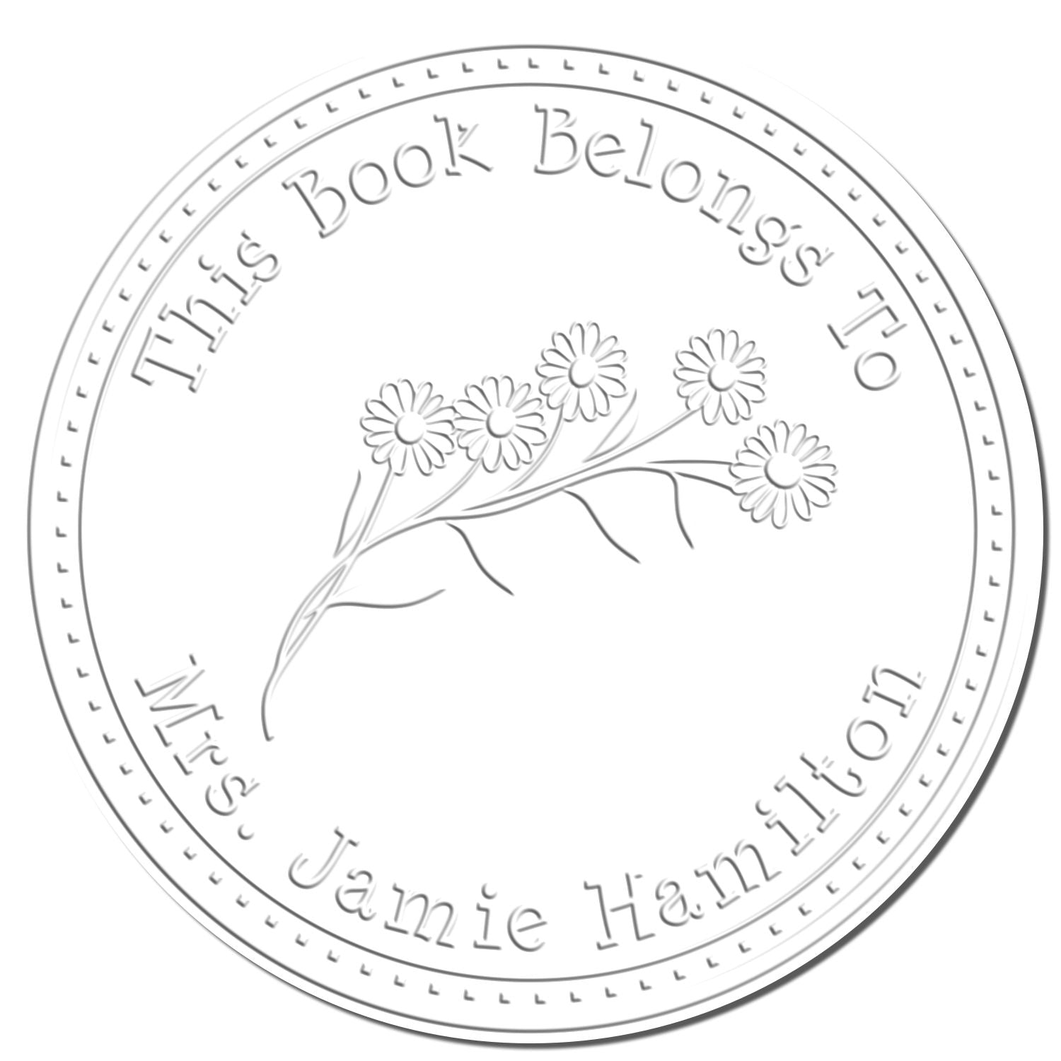 Silver embossed circular seal stamp with daisies and text, This Book Belongs To Jamie Hamilton.