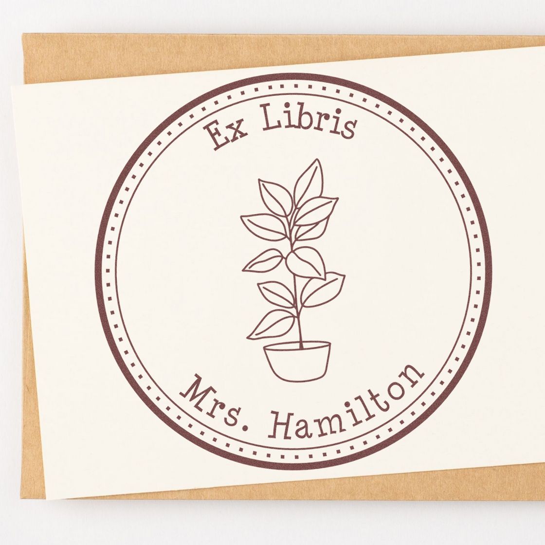 Burgundy circular personalized ex libris book stamp seal with potted plant and Ms. Hamilton on cream card
