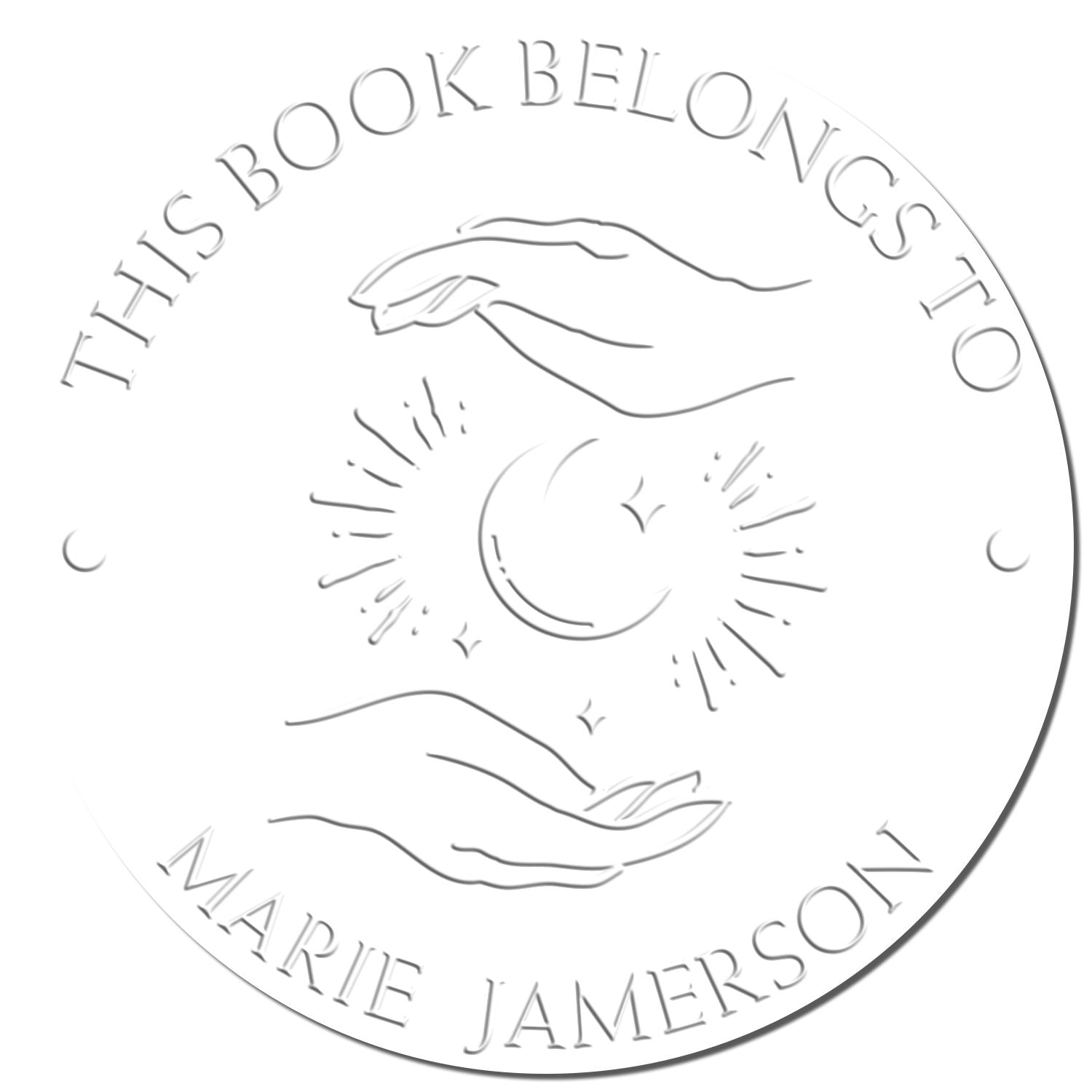 Circular silver embossing seal with hands, crescent moon and stars, reading This Book Belongs to Marie Jamerson.