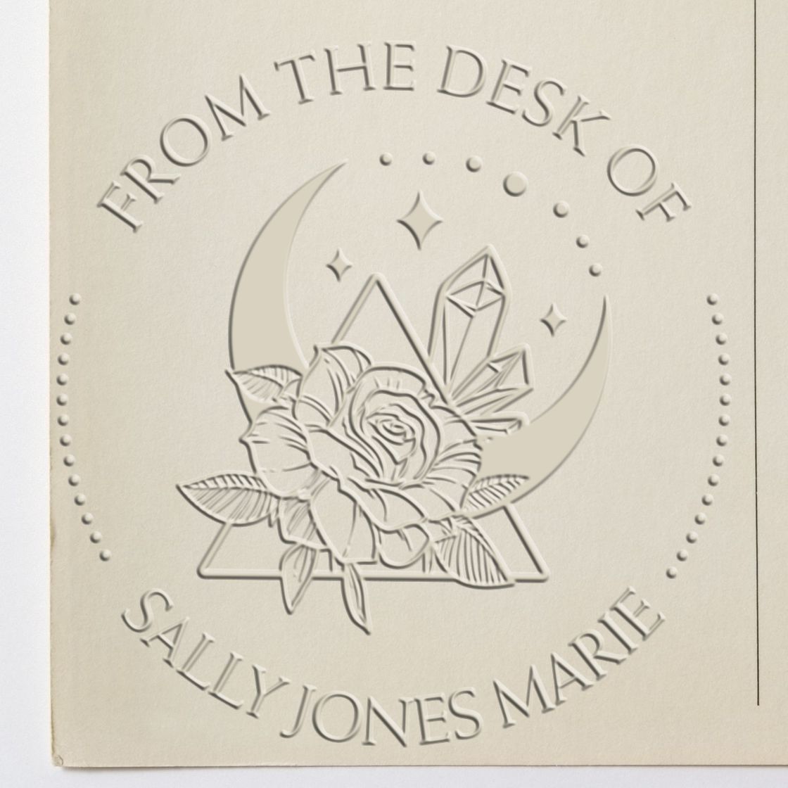 Embossed ivory stamp seal with rose, crescent moon and crystal, reading From the Desk of Sally Jones Marie.