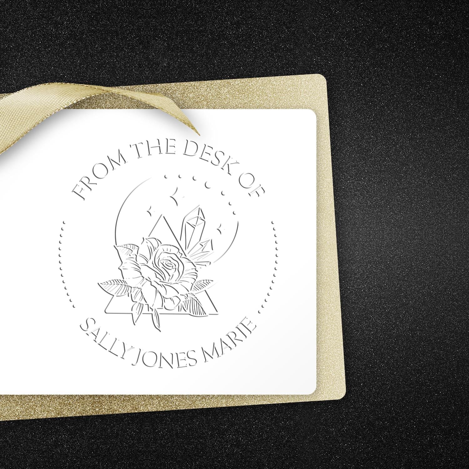 Custom stamp and seal card with gold ribbon, black glitter backdrop, and white floral monogram seal.