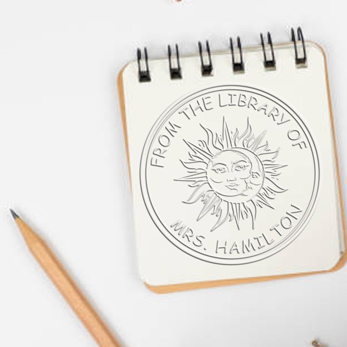 Shiny Soft Bewitching Sky personalized book ownership label seal with astrological design, in use on a book page.