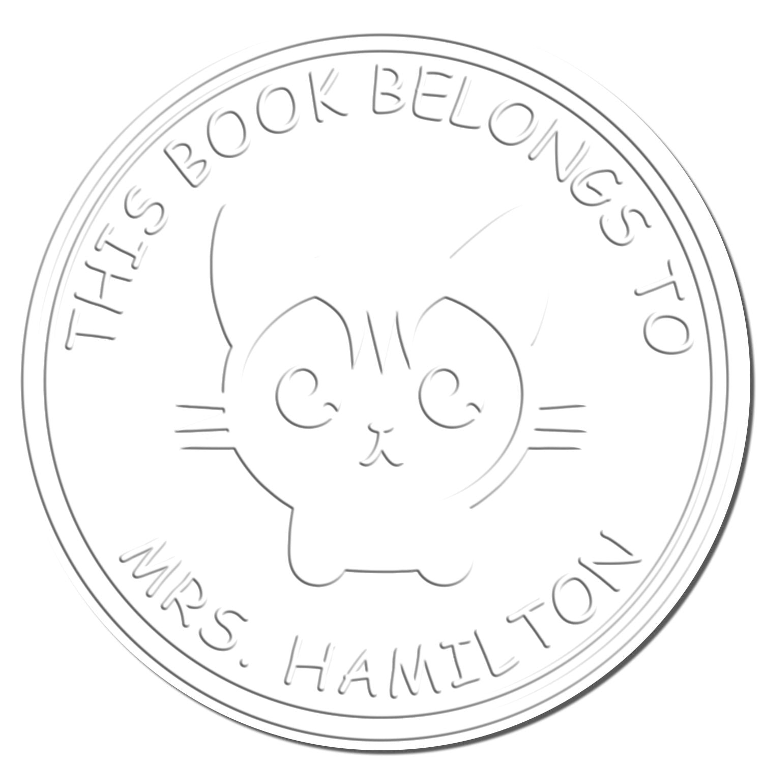 Light gray circular book stamp seal with a cute cat face and embossed text, This Book Belongs to Mrs. Hamilton, on white.