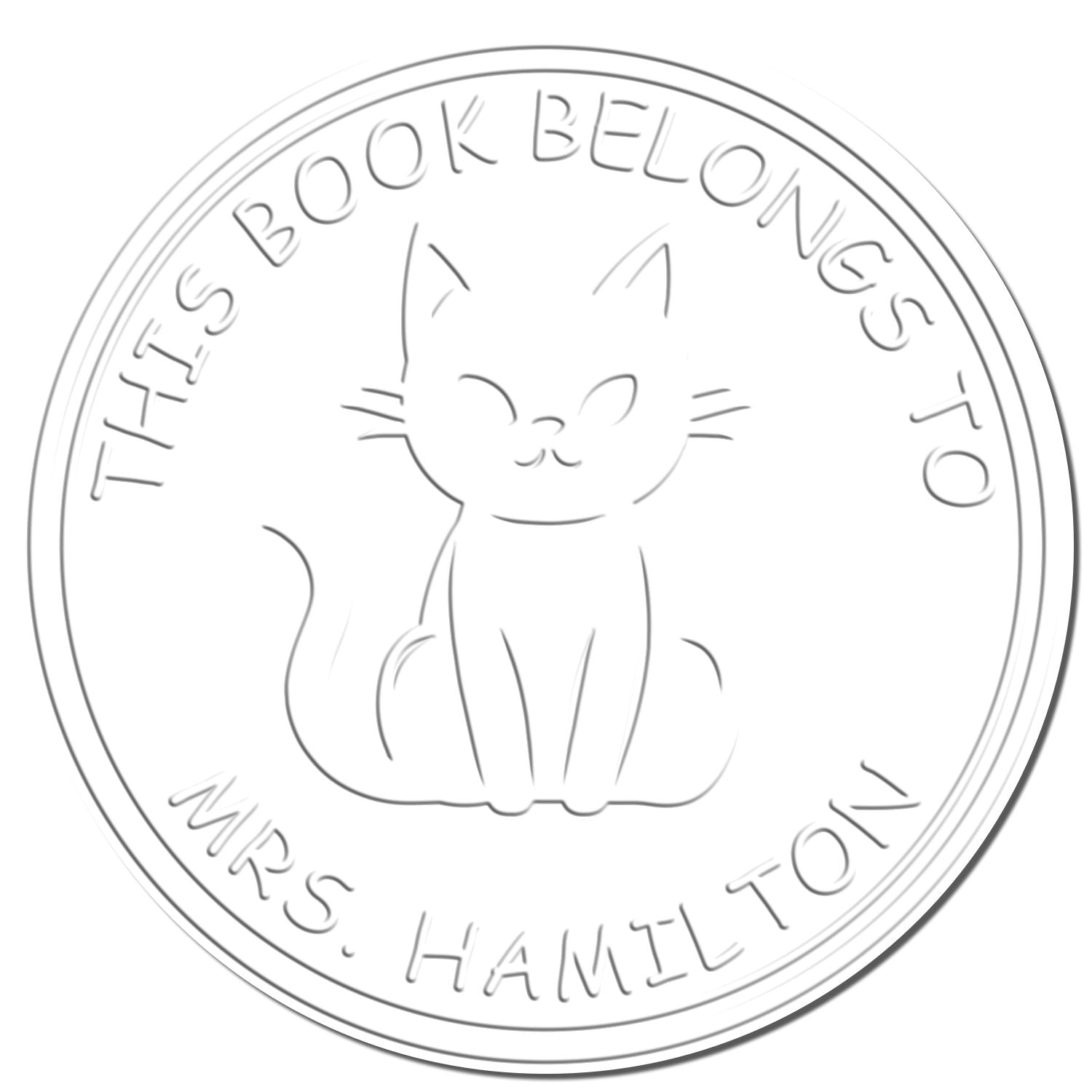 White circular book stamp with kitten seal and embossed text This Book Belongs to Mrs. Hamilton.