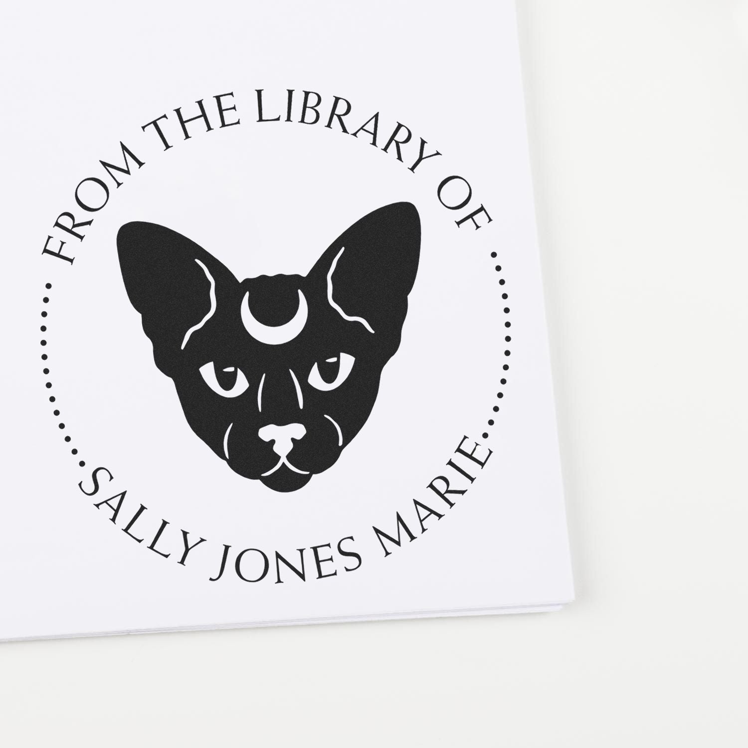Black personalized stamp seal with cat face, crescent moon, and circular text for Sally Jones Marie on white paper.