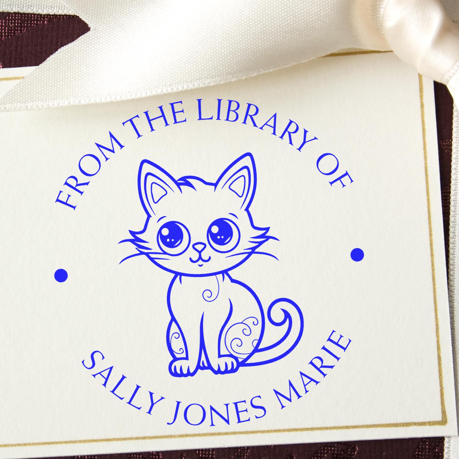 Blue cat custom rubber stamp seal with From the Library of Sally Jones Marie on ivory card with gold border.