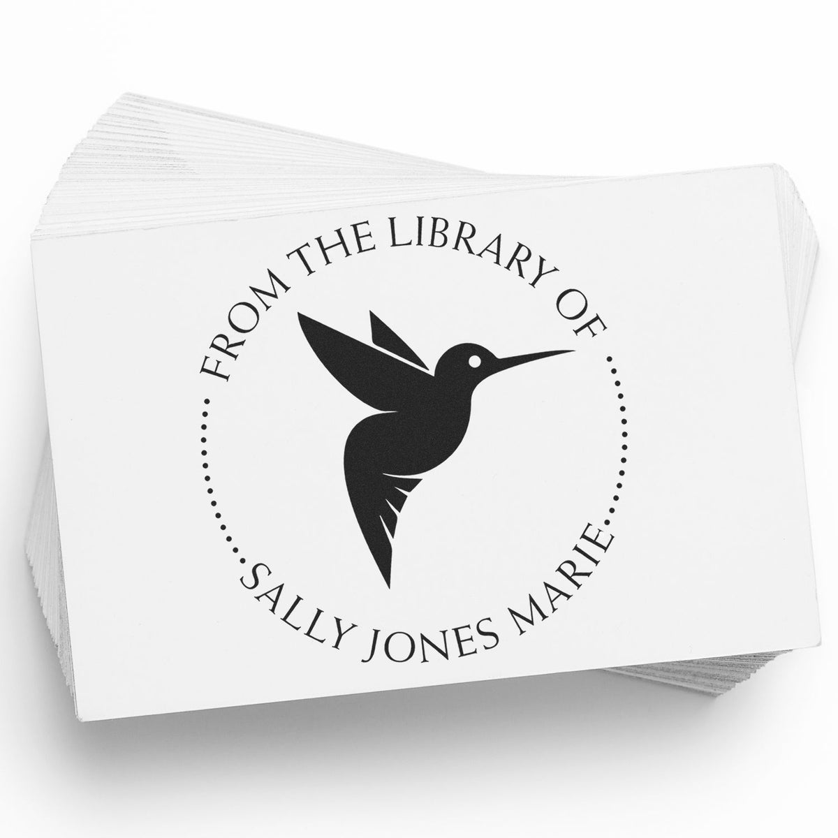 Stack of white library stamp cards with black hummingbird seal and From the Library of Sally Jones Marie text.