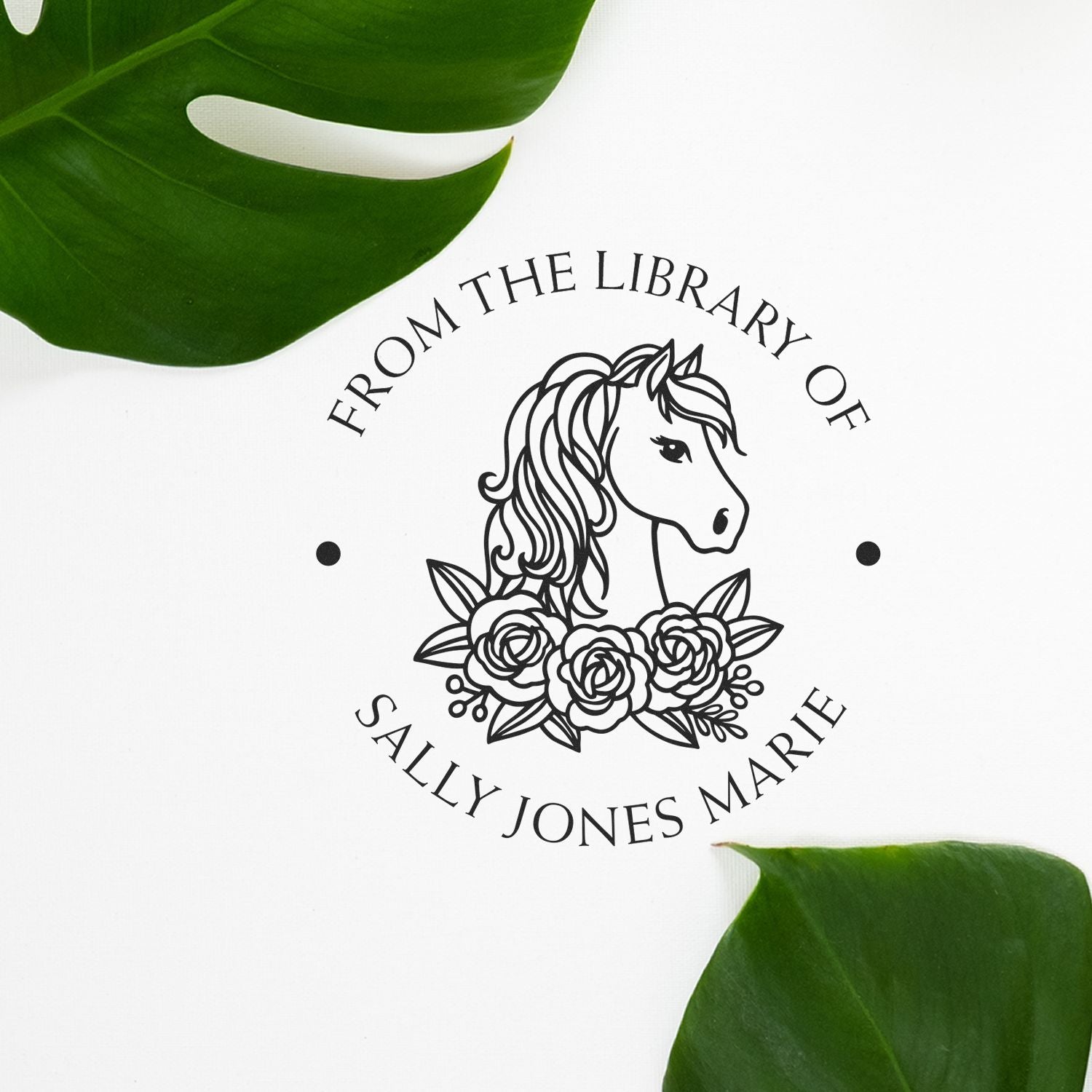 Custom black stamp seal with unicorn and roses, personalized text, on white with green leaves.