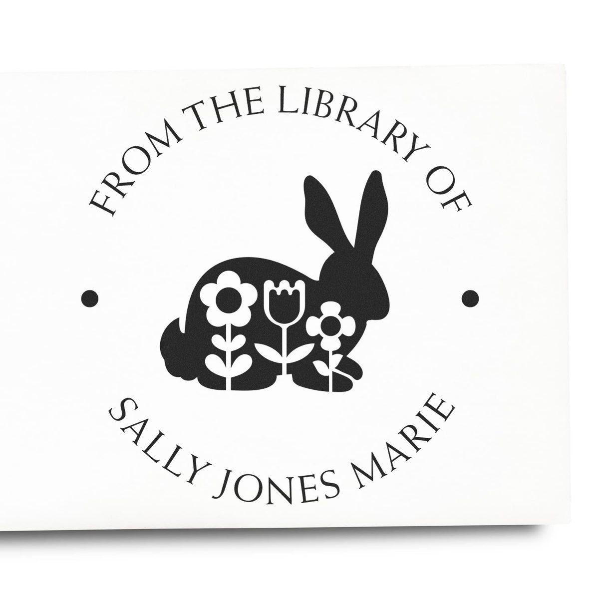 Black bookplate stamp seal with rabbit and flowers, reading ĀFrom the Library of Sally Jones MarieĀ on white background.