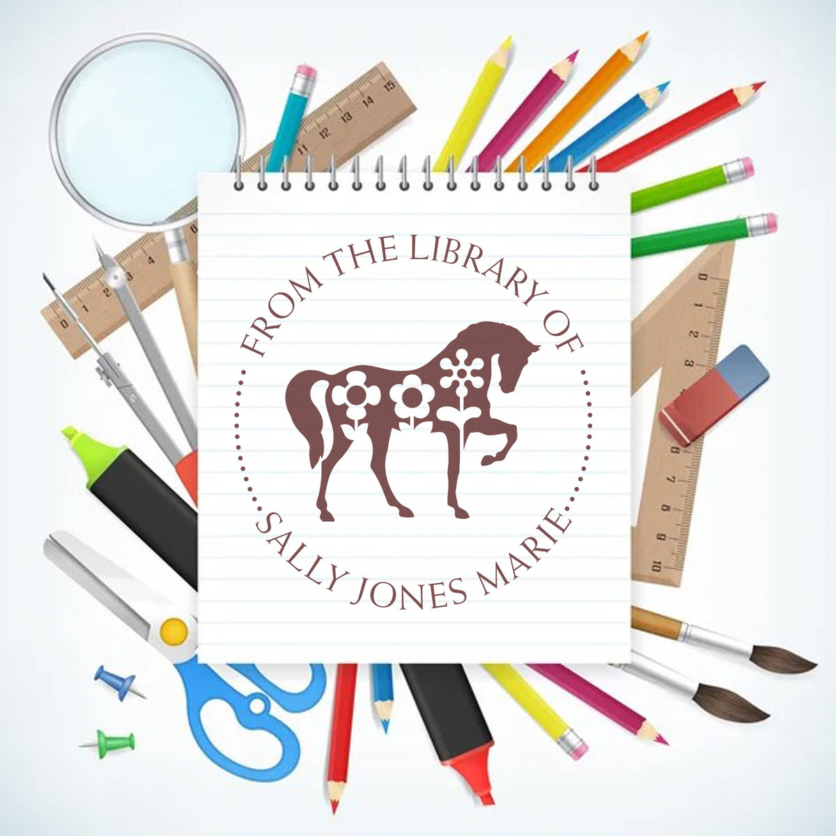 Custom round library stamp seal with brown horse silhouette on lined notebook, surrounded by colorful pencils, rulers, scissors, and brushes.