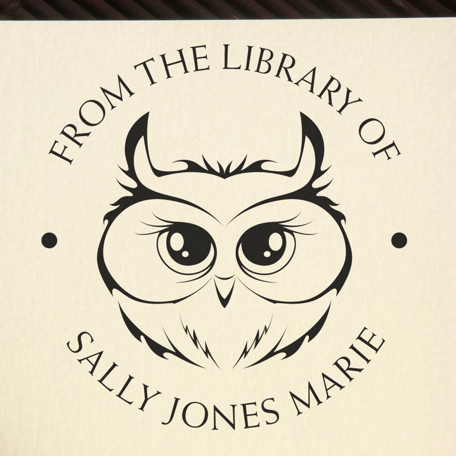 Black owl library stamp seal with circular text on a cream background for Sally Jones Marie.